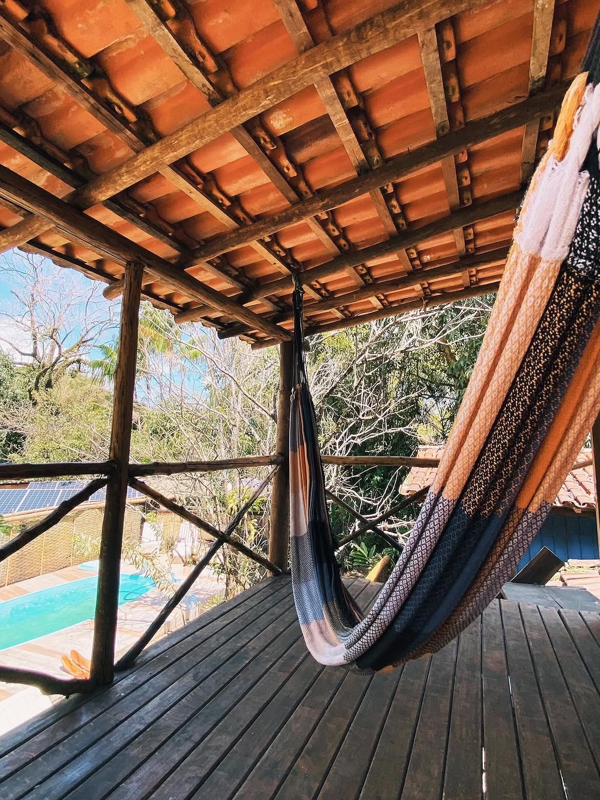 Varanda com rede e vista para a piscina